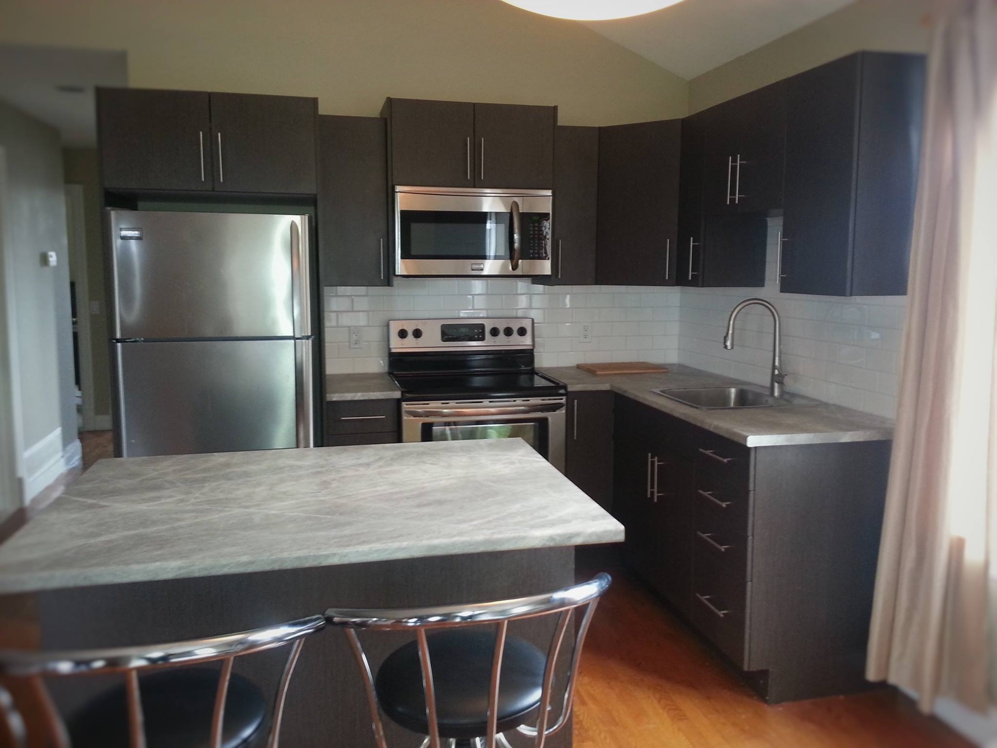 Contemporary dark kitchen with stainless appliances